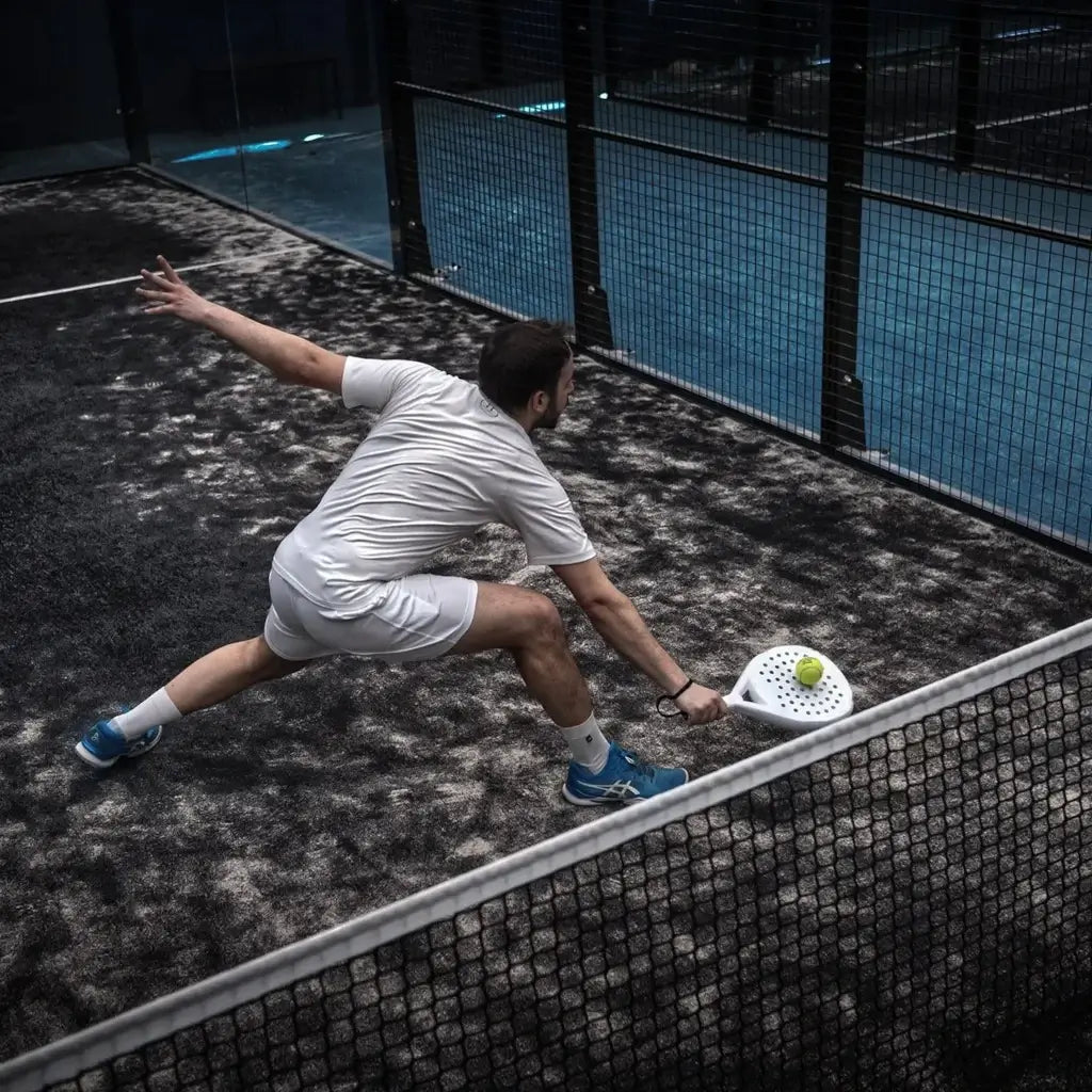 iam-Padel.com a division of iamRacketSports.com presents Hesacore Tour Padel Carbon under-grip. Player reaching for ball with hesacore grip installed on padel paddle.