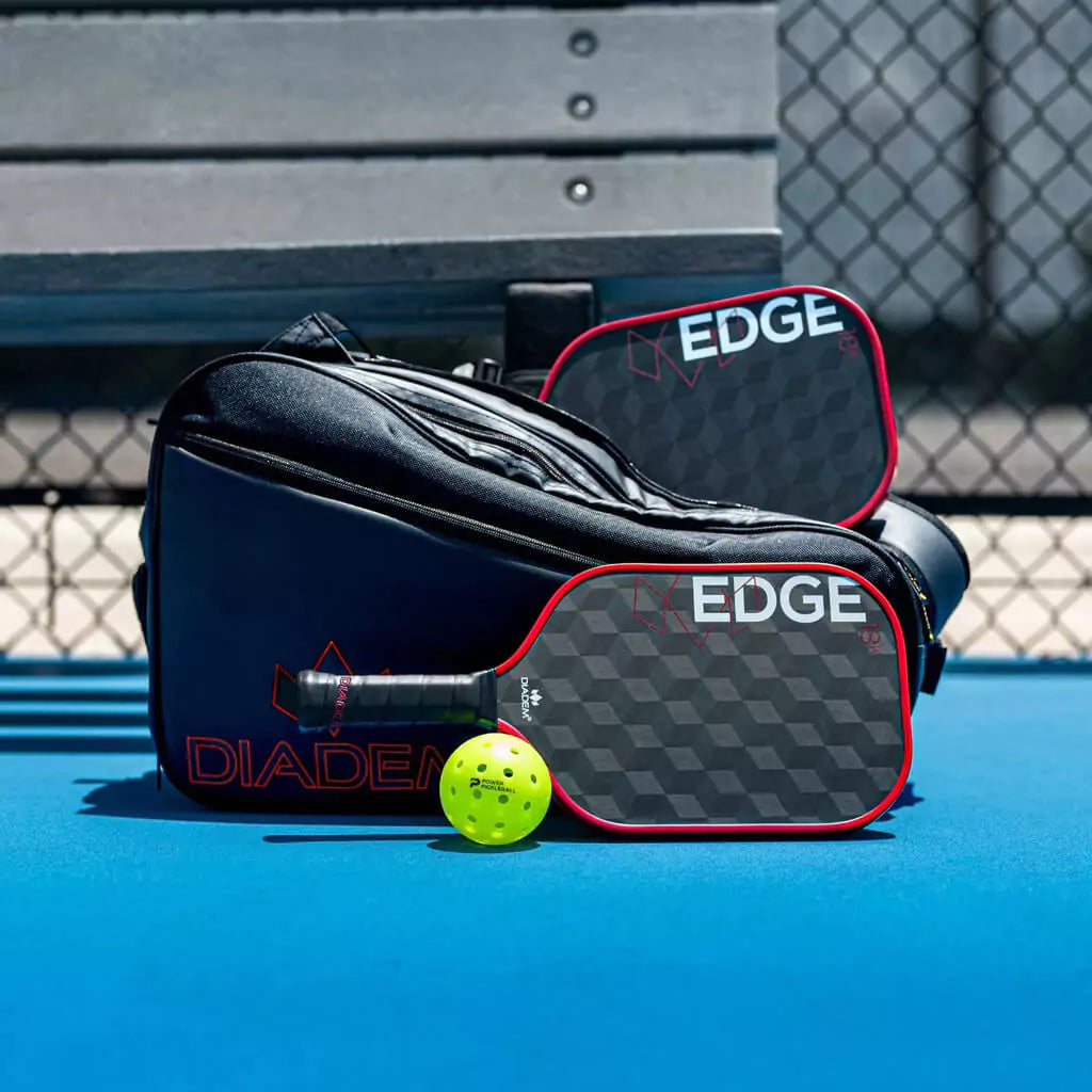SPORT: PICKLEBALL. Shop Diadem Sports Pickleball at "iamPickleball.Store" a division of "iamracketsports.com". Racket model is a 2023 Diadem Edge 18K advanced/professional Pickleball Paddle. Paddle is in vertical position. Paddle shown with diadem bag and balls.