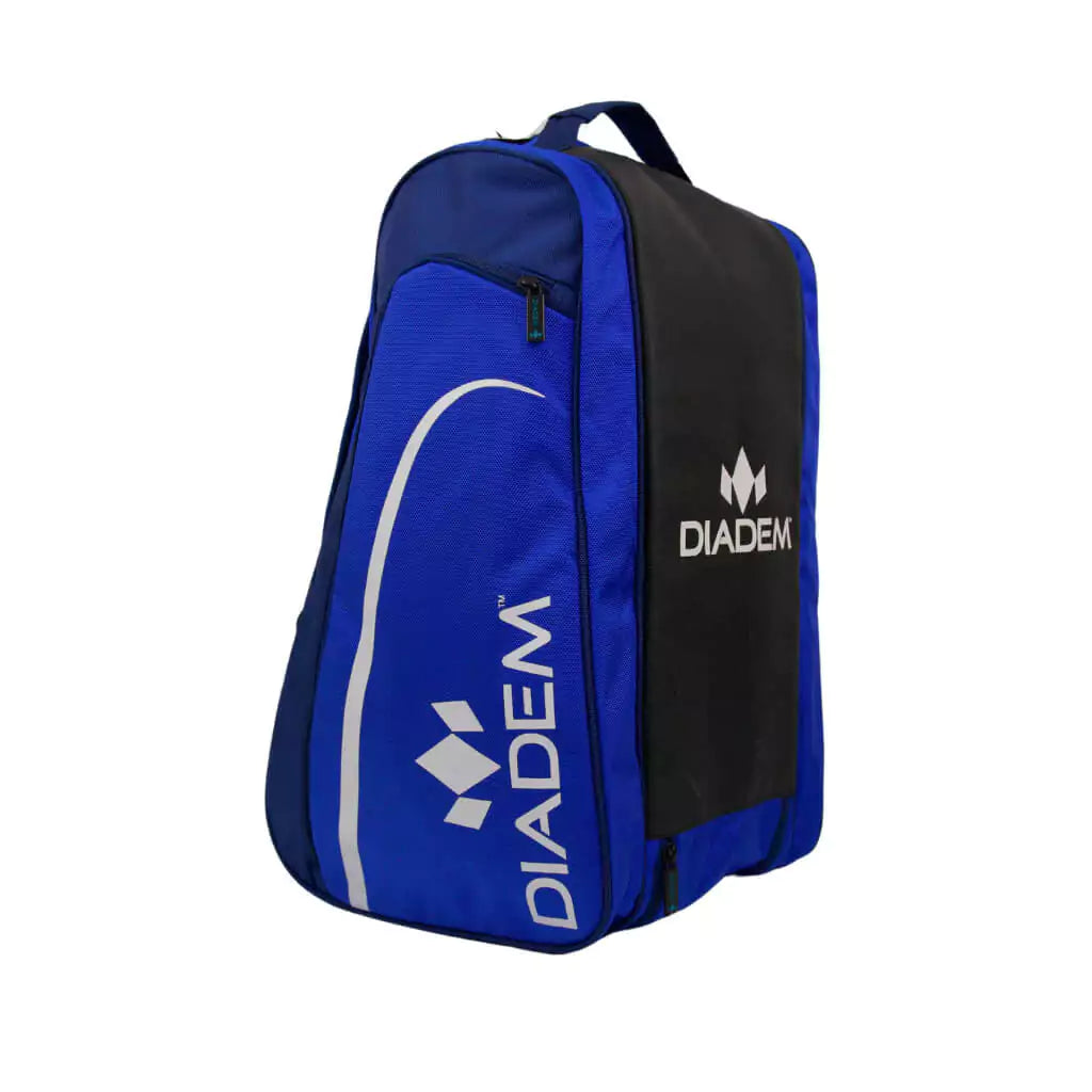 SPORT:PICKLEBALL. Shop Diadem at "iamracketsports.com", world wide shipping. Side view of Diadem Tour ELEVATE V3 Pickleball Paddle Bag, 3 paddle compartments, shoe compartment, side pockets, made from high quality nylon with adjustable handles, dimensions 21"x11"*12", Color navy/blue and white.