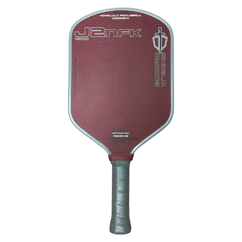 A Honolulu SWORD & SHIELD J2NFK Pickleball Paddle, in red, available from iamRacketSports.com.