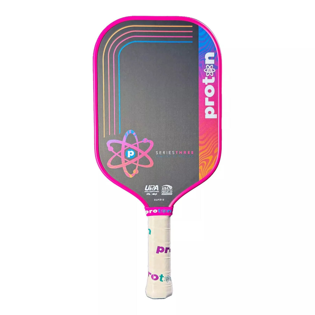 A Proton Series Three - Project Flamingo Elongated 13mm Pickleball Paddle with pink edge guard, available from IamRacketsports.com, online and in-store, Miami USA, worldwide shipping.