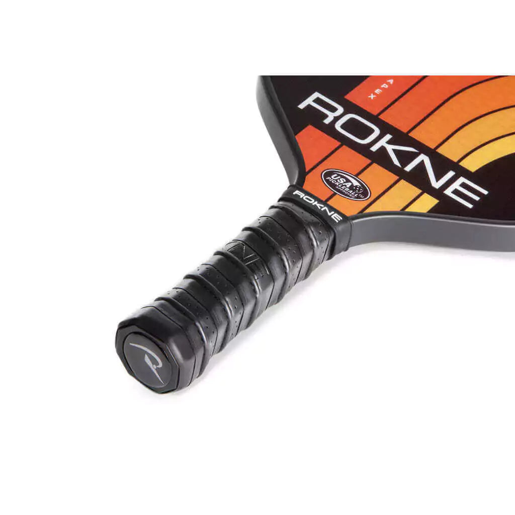 SPORT: PICKLEBALL. Shop Rokne Pickleball at iambeachtennis maimi Racket and Paddle Sports store. Racket model is a 2023 Rokne Curve Apex TANGERINE Pickleball Paddle/racket for beginner and intermediate players. Neck and handle view of Racquet/Paleta.