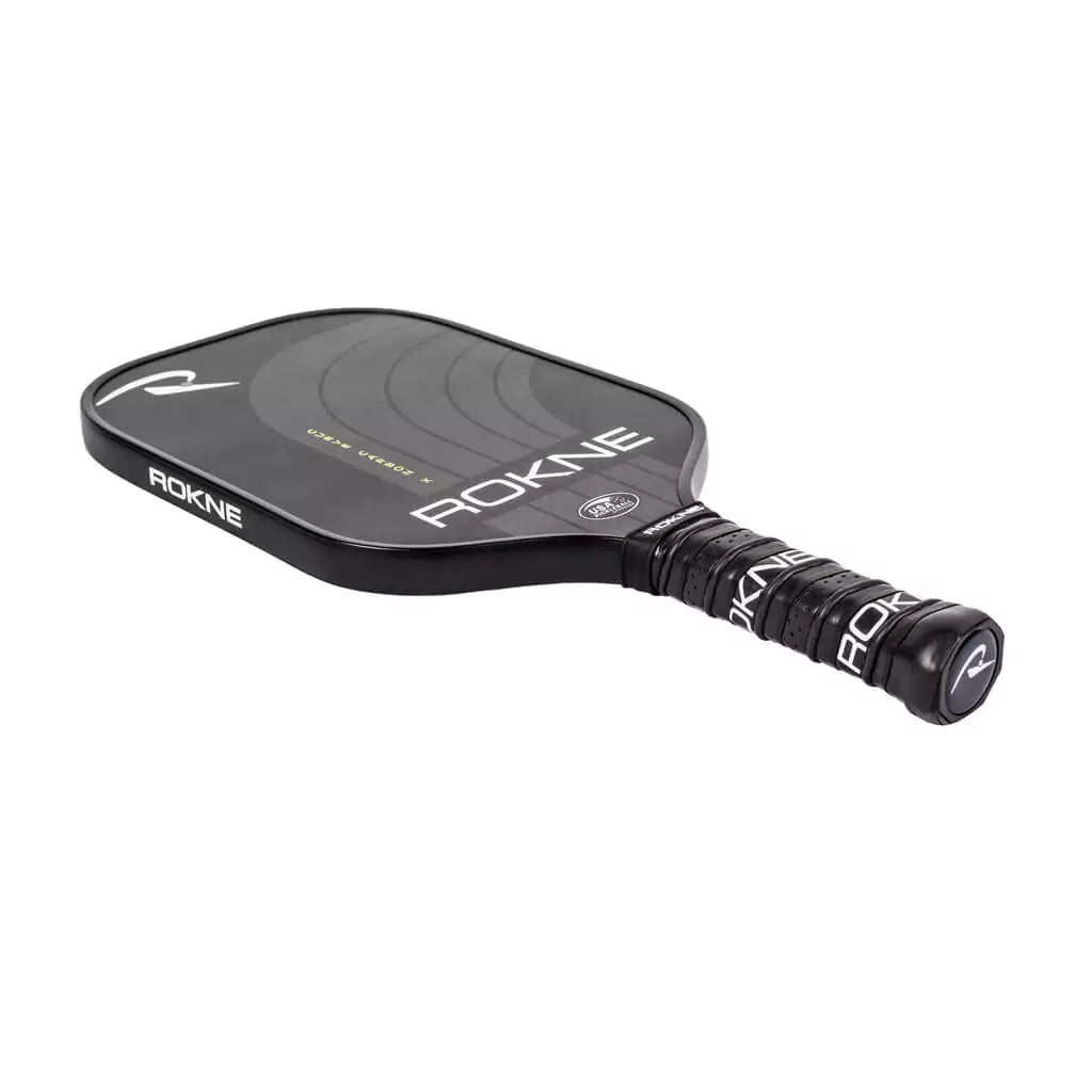 SPORT: PICKLEBALL. Shop Rokne Pickleball at iamRacketSports, Miami, Florida, USA. Racket model is a 2023 Rokne Curve Carbon x NIGHTFALL Pickleball Paddle/racket for advanced and professional players. Racquet/Paleta face.