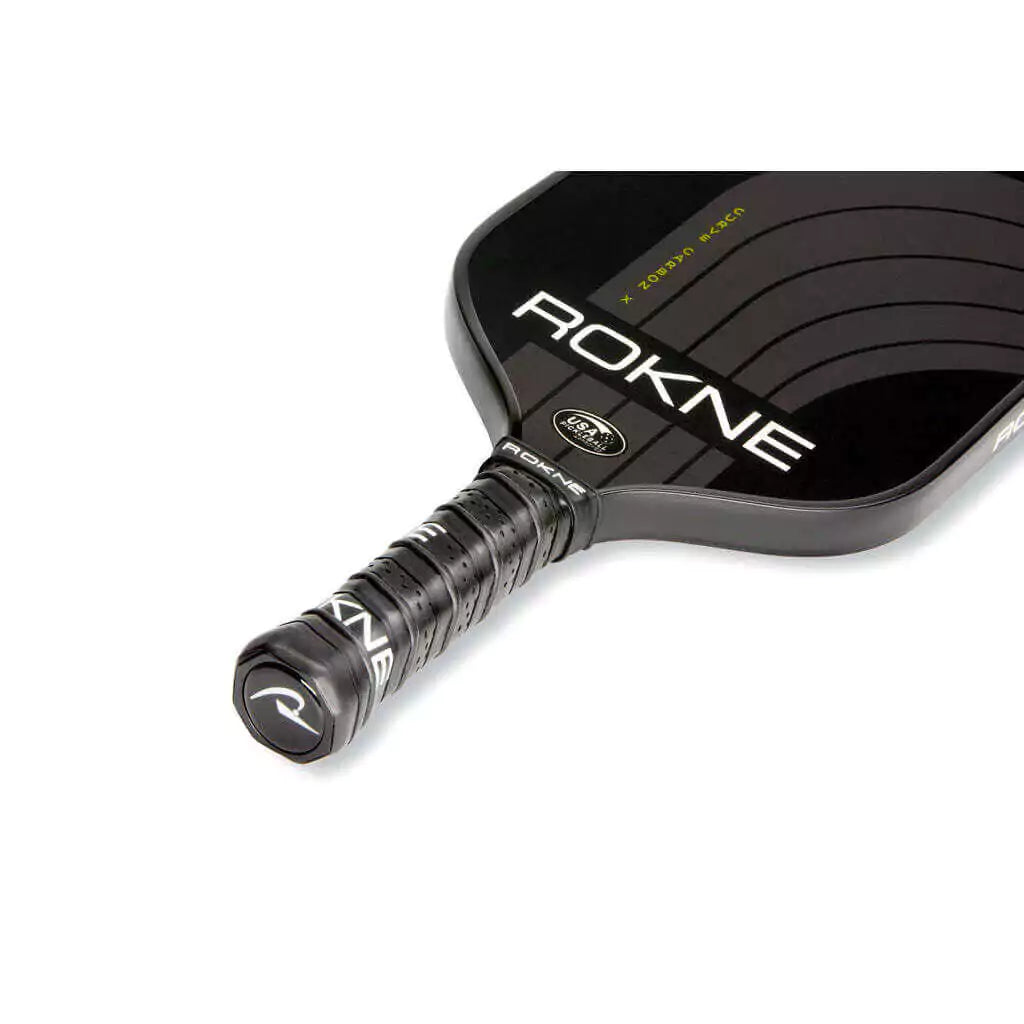 SPORT: PICKLEBALL. Shop Rokne Pickleball at iambeachtennis maimi Racket and Paddle Sports store. Racket model is a 2023 Rokne Curve Carbon x NIGHTFALL Pickleball Paddle/racket for advanced and professional players. Neck and handle view of Racquet/Paleta.
