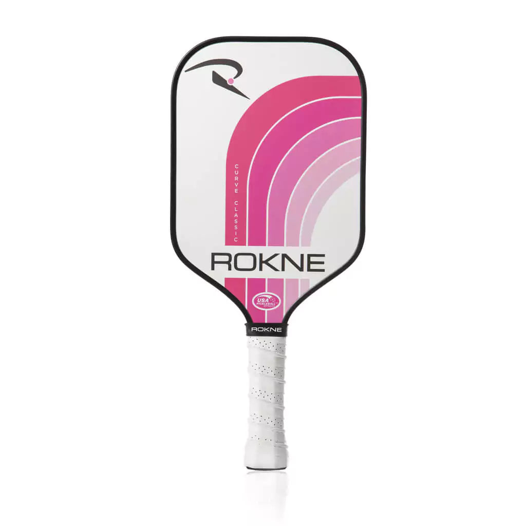SPORT: PICKLEBALL. Shop Rokne Pickleball at USA premier Racket and Paddle Sports store, "iamracketsports". Racket model is a 2023 Rokne Curve Classic BUBBLEGUM Pickleball Paddle/racket for beginner and intermediate players. Racquet/Paleta is in vertical orientation.