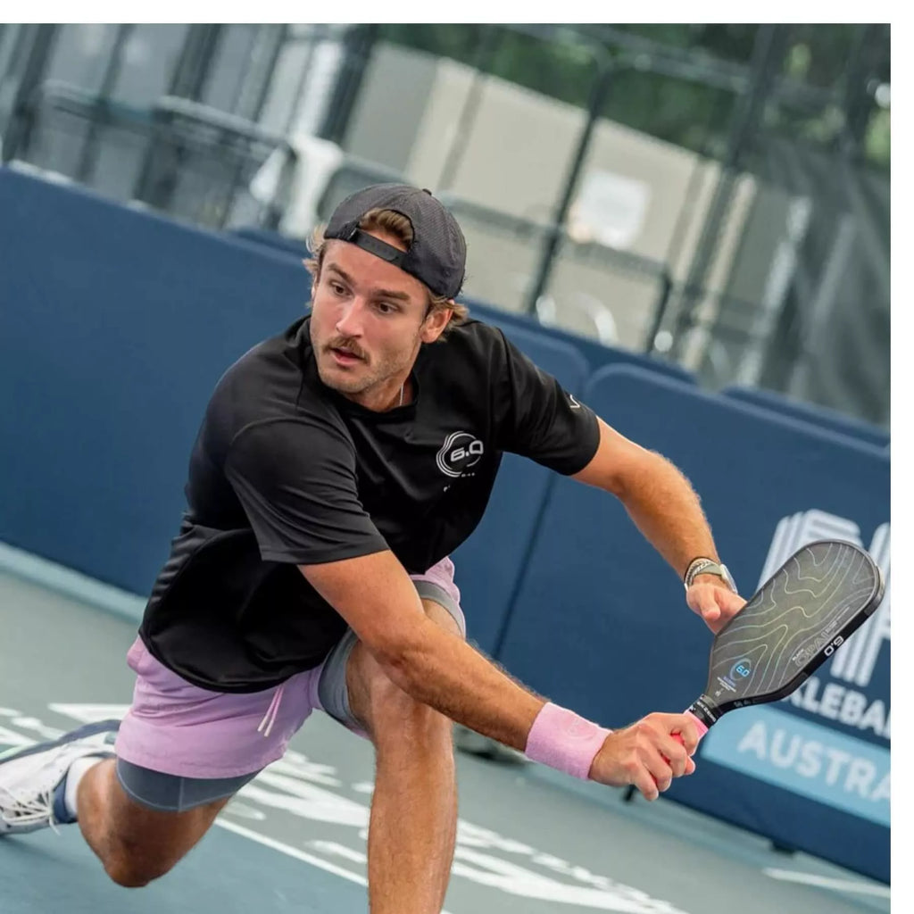 A player using a Six Zero BLACK OPAL 14mm Pickleball Paddle,  available from IamRacketsports.com, online and in-store, Miami USA, worldwide shipping