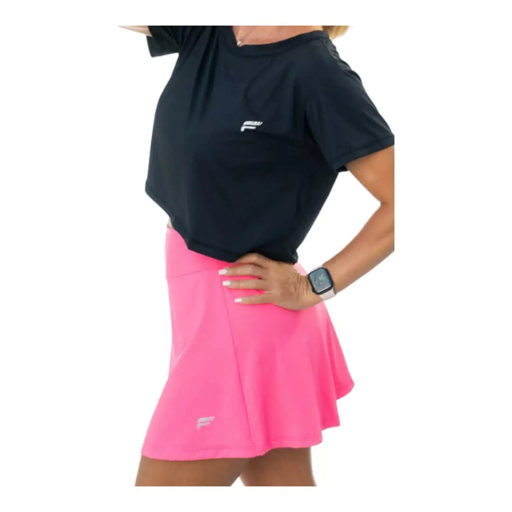 SPORT:BEACH TENNIS. Shop Flow Beach tennis at iamBeachTennis Boutique store. A striding female model wearing a pink Flow Beach Tennis LAGUNA Beach Tennis Skirt.
