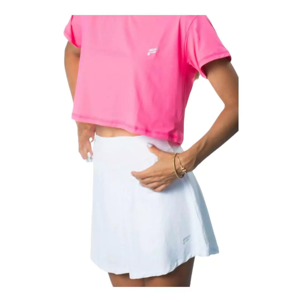 SPORT:BEACH TENNIS.  Shop Flow Beach tennis at iamBeachTennis online store . Female model facing outwards wearing a white  Flow Beach Tennis LAGUNA Beach Tennis Skirt.
