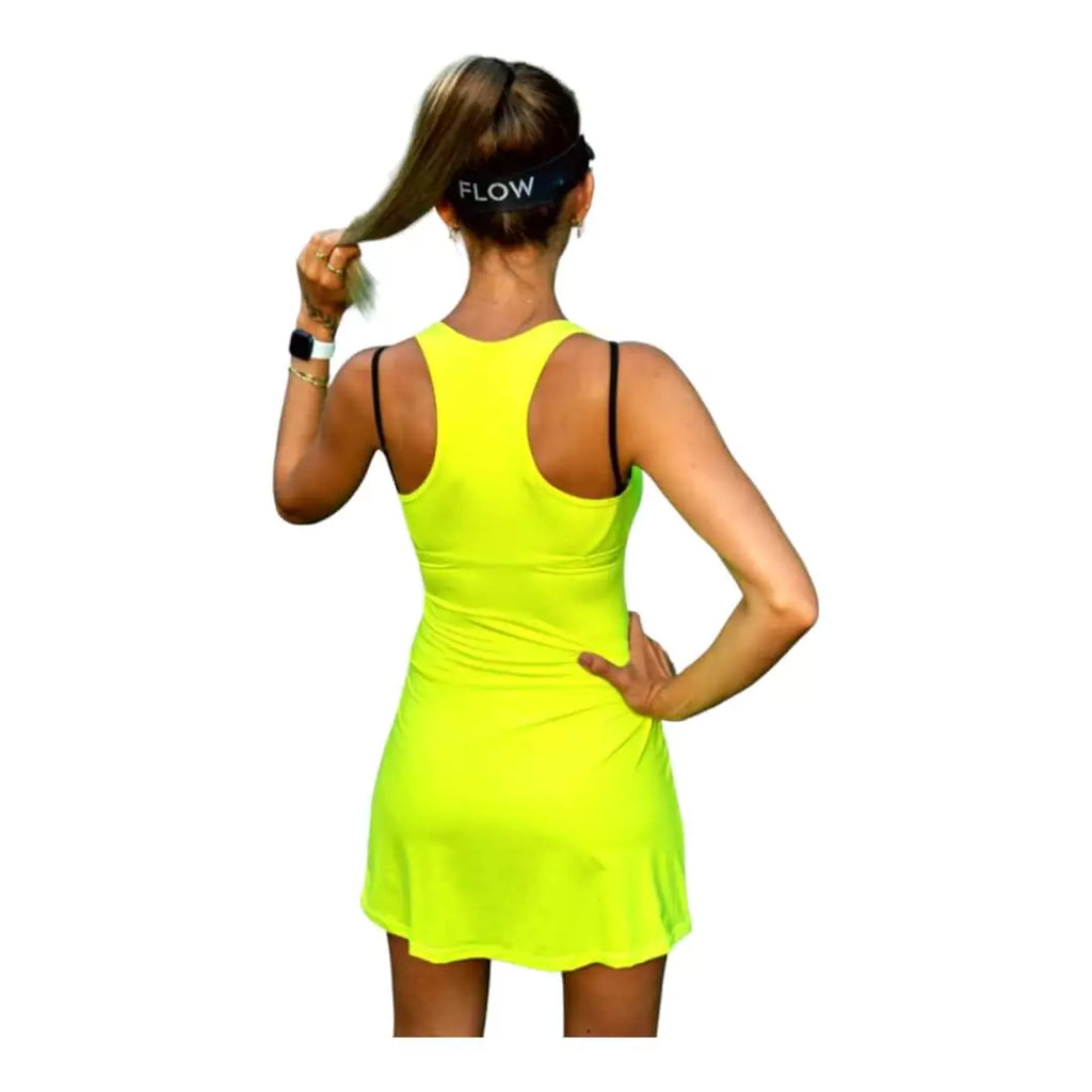 SPORT:BEACH TENNIS. Shop Flow Beach tennis at iamBeachTennis miami shop. Female model, back turned wearing a green Flow MIAMI Cut Out Back Slim Dress
