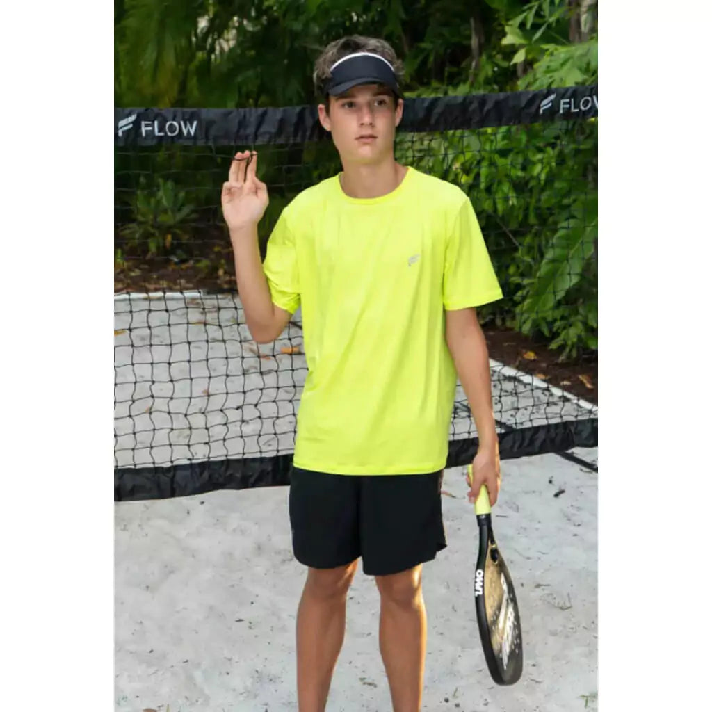 SPORT:BEACH TENNIS. Shop Flow Beach tennis at iamRacketSports Depot Store. Young male beach tennis player wearing a green Flow Beach Tennis ALOHA T-SHIRT on court.