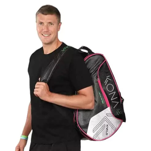 A person using a Kona K-VALO Beach Tennis Racket Bag, available from iamBeachTennis.com, online and from Miami instore.  
