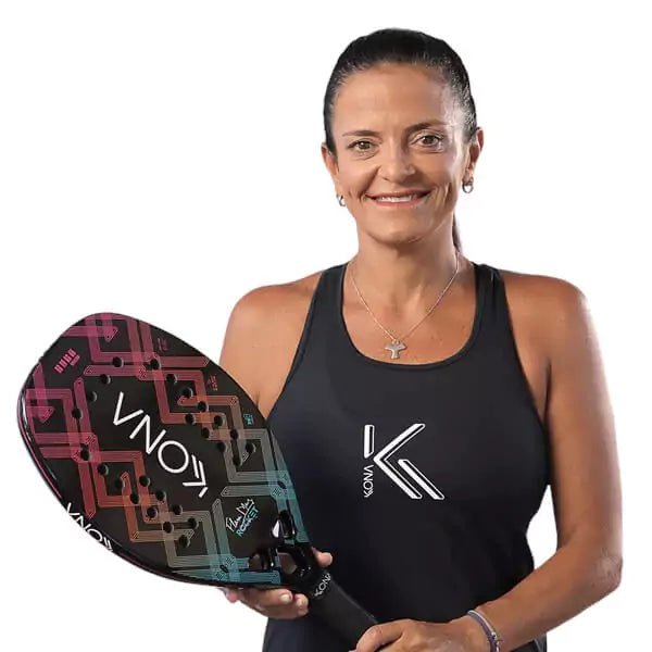 A player holding  a Kona K-DOZE PINK 2024 Beach Tennis Paddle. Shop Kona at i am Beach Tennis store.