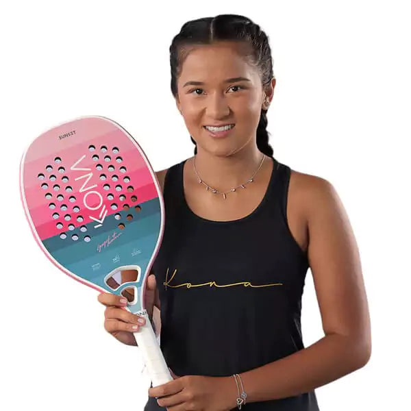 Player holding  a Kona SUNSET SKY 2024 Beach Tennis Paddle. Shop Kona at i am Beach Tennis store.