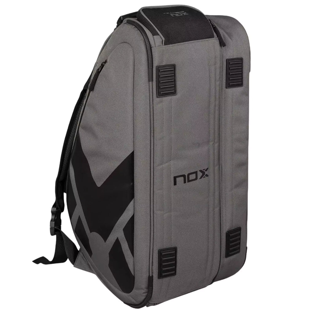 A standing gray and black, Nox AT10 TEAM Padel Racket Bag with open side compartment, available from "iamracketsports.com", Miami shop.