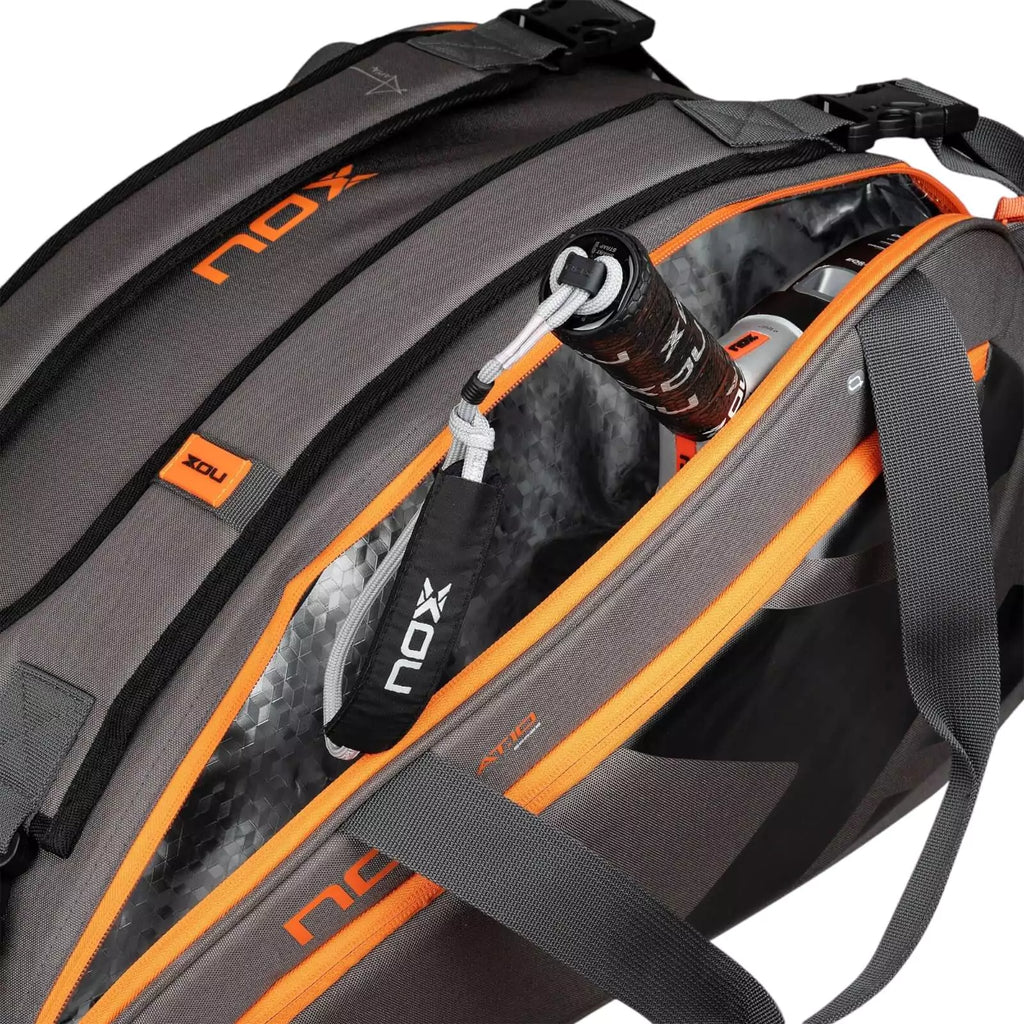 A standing Nox AT10 TEAM Padel Racket Bag with open racket compartment, available from "iamracketsports.com", Miami shop.