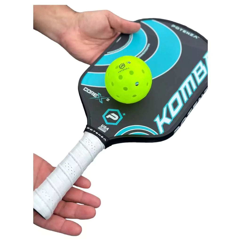 A player holding a  Potenza KOMBA+CORE*2 Pickleball Paddle, available at iamracketsports.com.