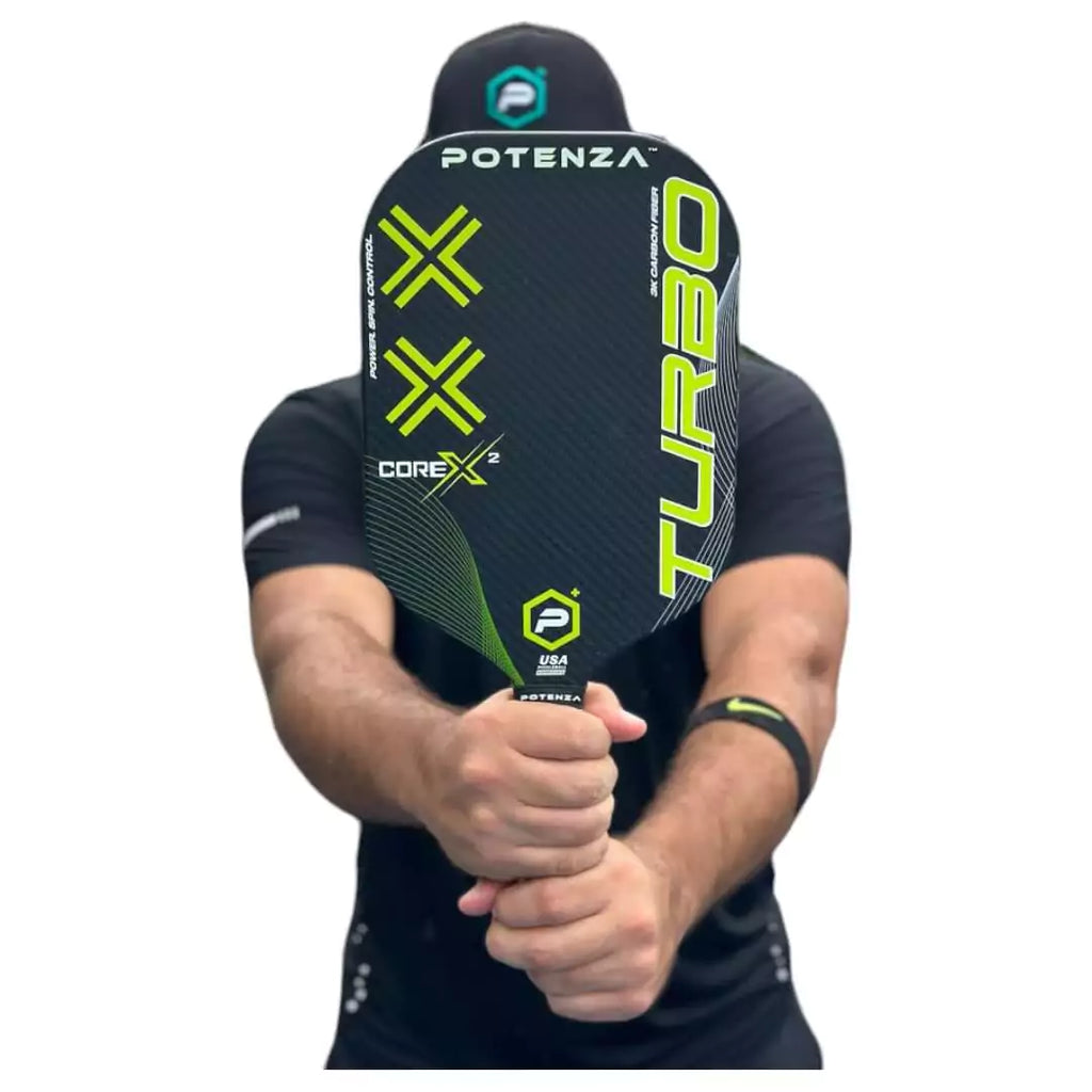 A player holding a Potenza TURBO+CORE*2 Pickleball Paddle, available at iamracketsports.com.