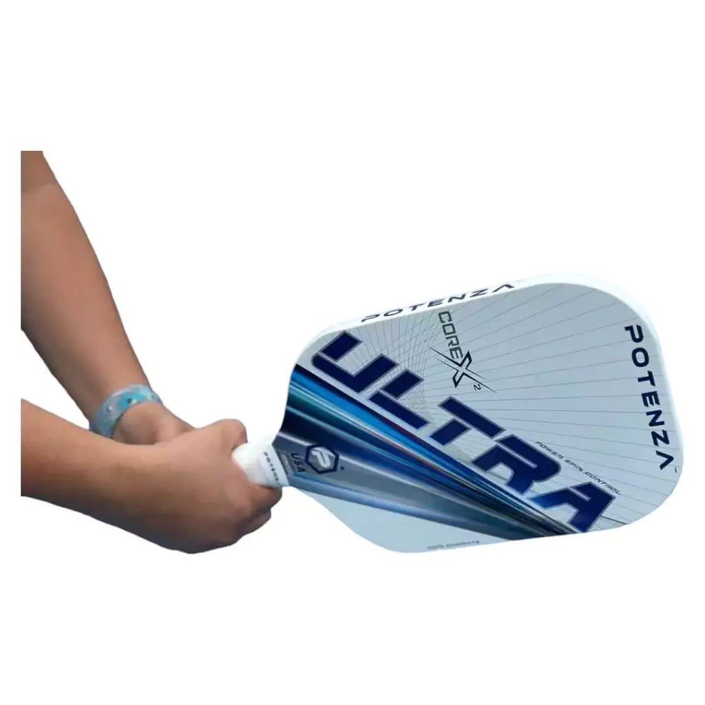 A player holding a  Potenza ULTRA+ CORE*2 Elongagted Pickleball Paddle. Shop for Potenza at iamRacketSports.com, Miami warehouse store.