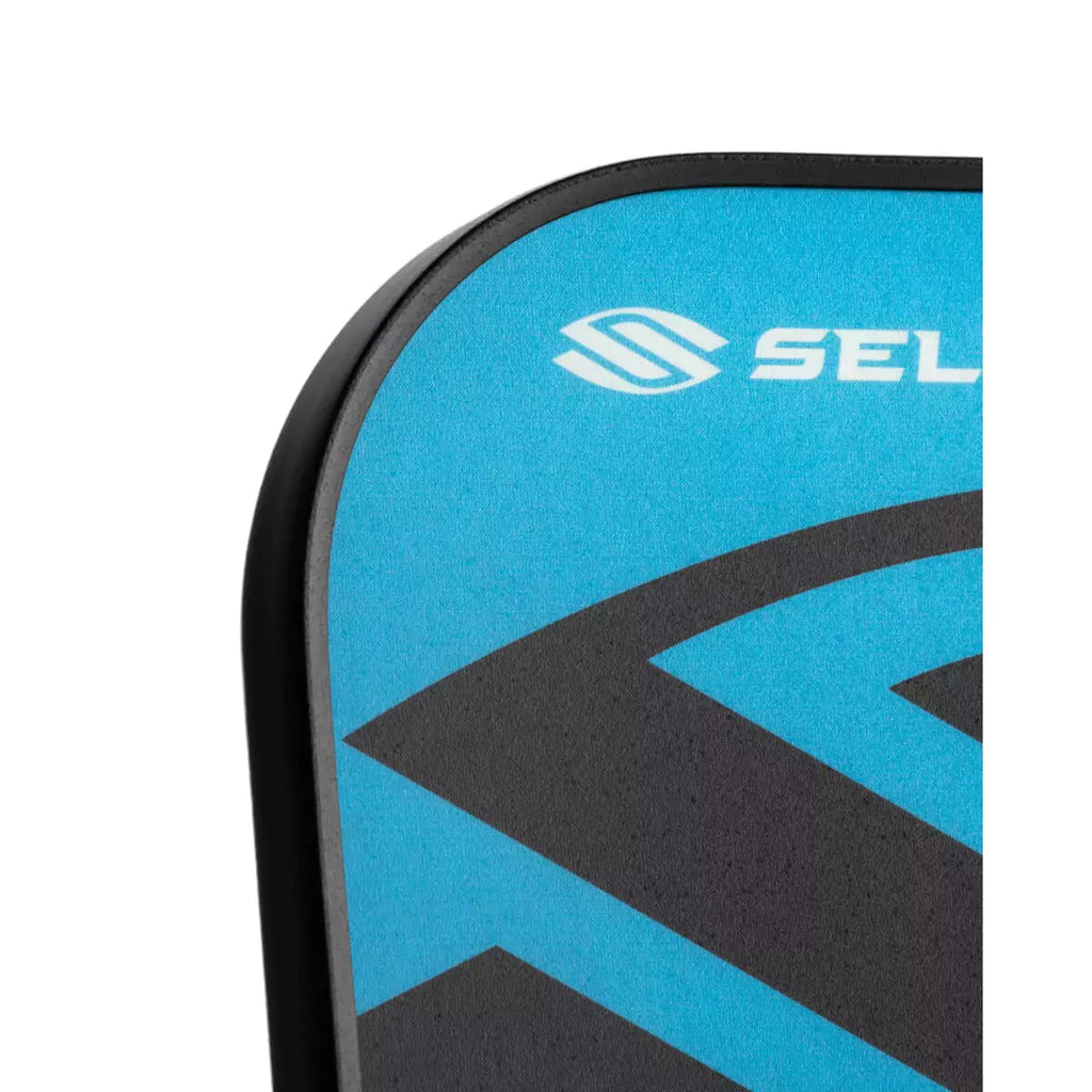 The top left corner of the face of a blue
Selkirk AMPED Control S2 16mm Pickleball Paddle,
Available from iamPickleball.store.