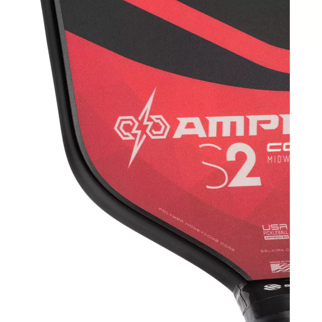 A partial view of a red 
Selkirk AMPED Control S2 16mm Pickleball Paddle,
FiberFlex + Fiberglass surface with 
a durable spin coating and X5 Honeycomb core.
Available from iamPickleball.store.
