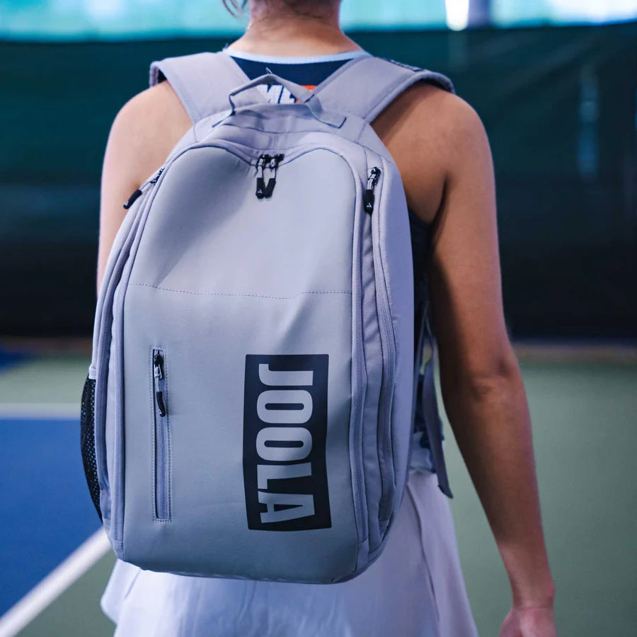 A player wearing a Joola VISION II Backpack Bag Gray/Black, available from IamRacketsports.com, online and in-store, Miami USA.