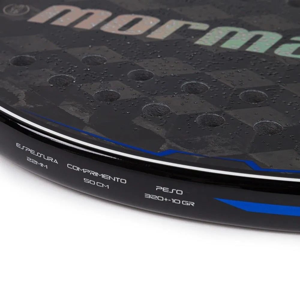 The edge of a Mormaii TRIAX CONCEPT 2024 Professional Beach Tennis Paddle,
available from at iamBeachTennis.com.
