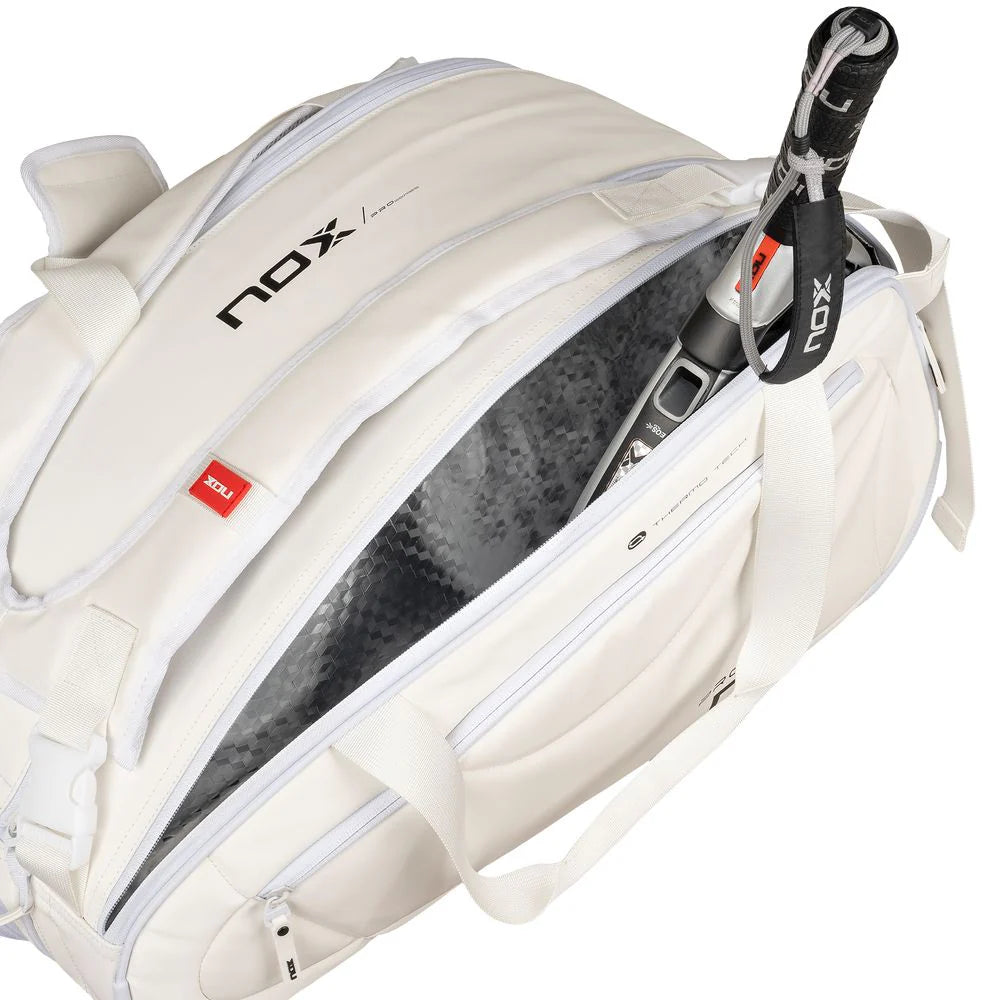 A Nox PRO Series White Racket Bag with open racket compartment and paddle, available from iamRacketSports.com, in store and online.