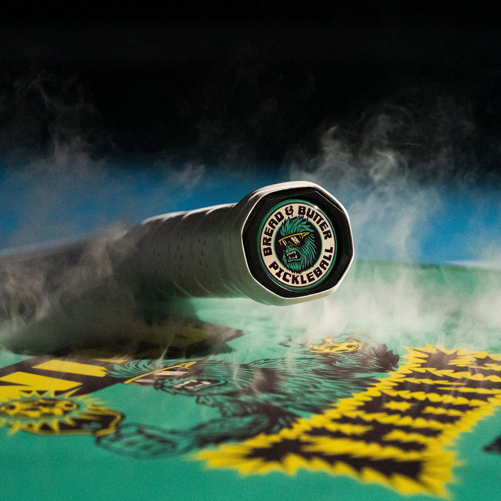 Handle butt and logo of the Bread & Butter THE WILD THANG 16mm Pickleball Paddle, available from iamRacketSports.com, online and in store, Miami USA.