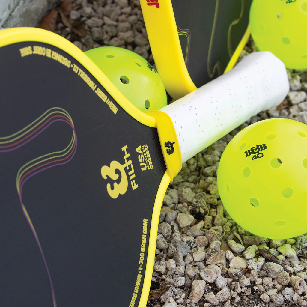 A yellow edged Bread & Butter Filth 16mm 2024 Elongated Pickleball Paddle, available at iamracketsports.com, Miami shop.