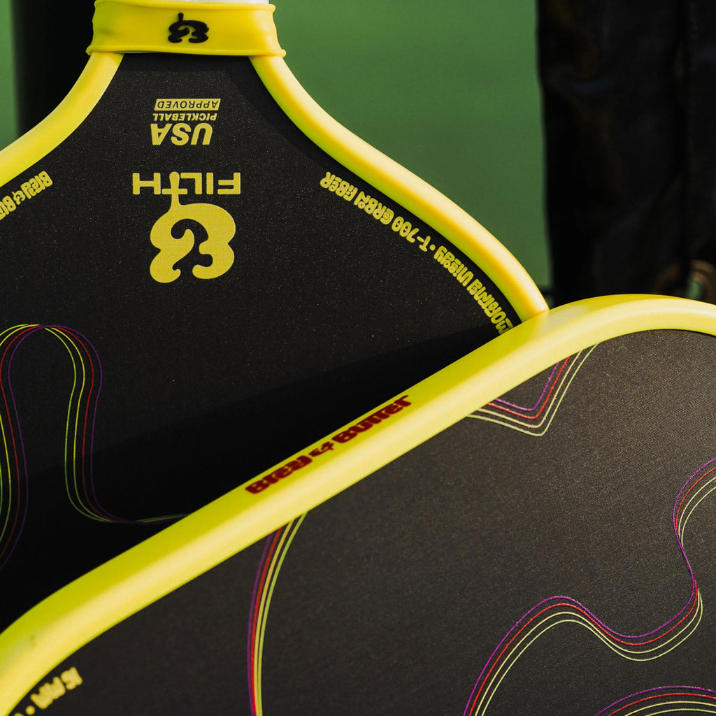 A pair of Bread & Butter Filth yellow edge guard, 16mm 2024 Elongated Pickleball Paddles,  available at iamracketsports.com, Miami shop.