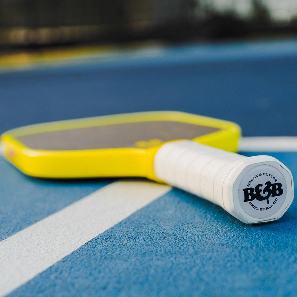 A Bread & Butter Filth yellow edge guard, 16mm 2024 Elongated Pickleball Paddle,  on court  available at iamracketsports.com, Miami shop.