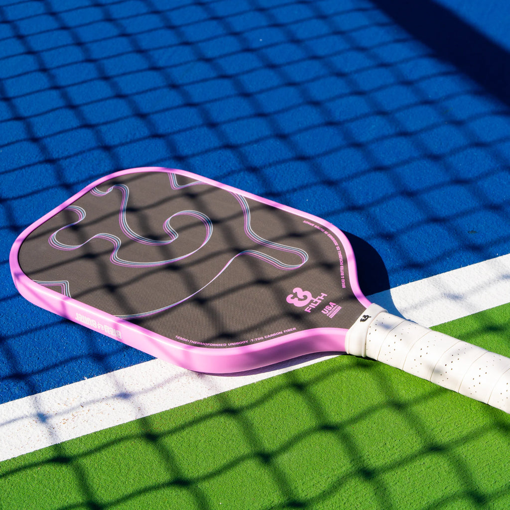 A pink  Bread & Butter Filth 16mm 2024 Elongated Pickleball Paddle, available at iampickleball.store.