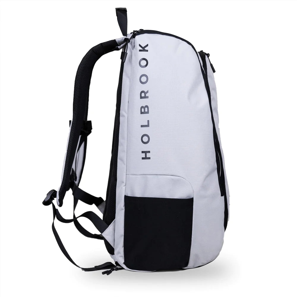  SPORT:PICKLEBALL.Shop Holbrook Pickleball at "iamracketsports.com" Miami.  A Holbrook pickleball Podium paddle/racket rucksack bag in light grey with black zips.  Bag in side on view showing black mesh side pocket.