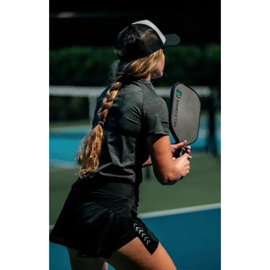 A player holding a Killa Dinks RUSH-01 PickleBall Paddle. Shop for at iamRacketSports.com.