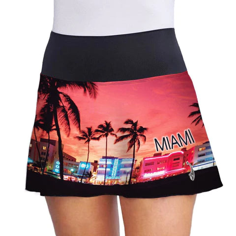 SPORT: PICKLEBALL. Shop Lacoa Sports clothing at "iamPickleball.Store" a division of "iamracketsports.com".  Front view of Miami Beach Skirt with print on black of sunset on Miami boulevard with vibrant colors,  palm trees and buildings.