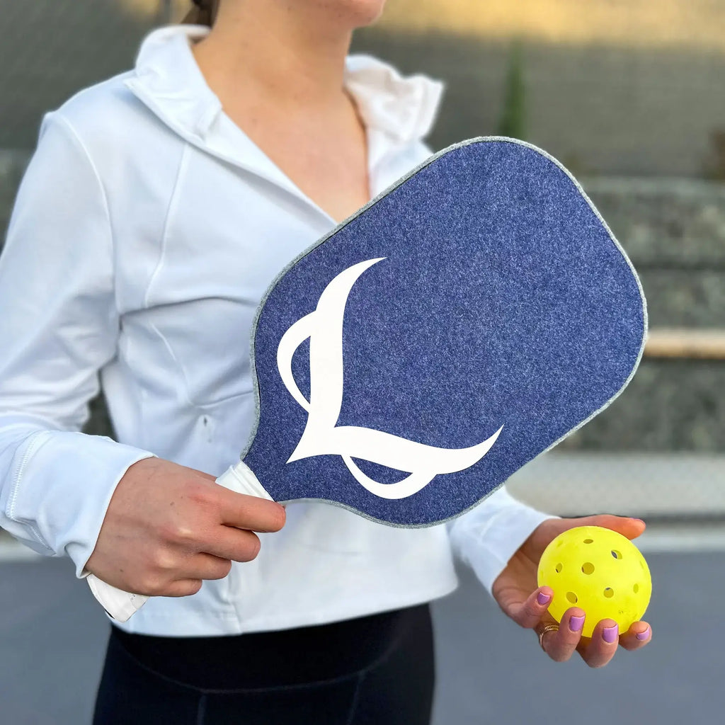 Player holding the OWL PXE Pickleball 13mm Elongated Paddle, purchase from iamPickleball.store.