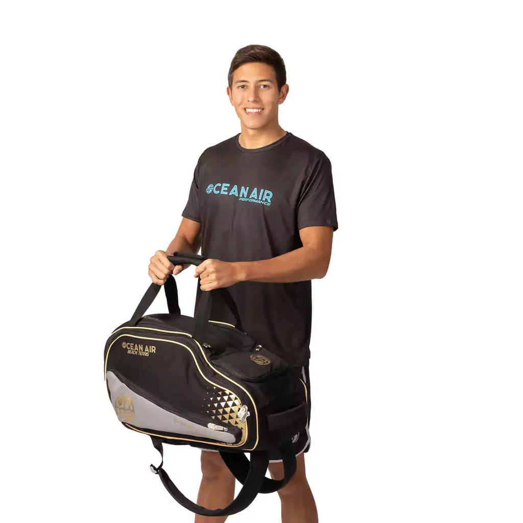 Shop BT Bags at iamBeachTennis, world wide shipping - Bag model is an Ocean Air Performanace PRO BT COMPACT bag in Black. Bag carried by Diego Guzman a Beach Tennis Player.