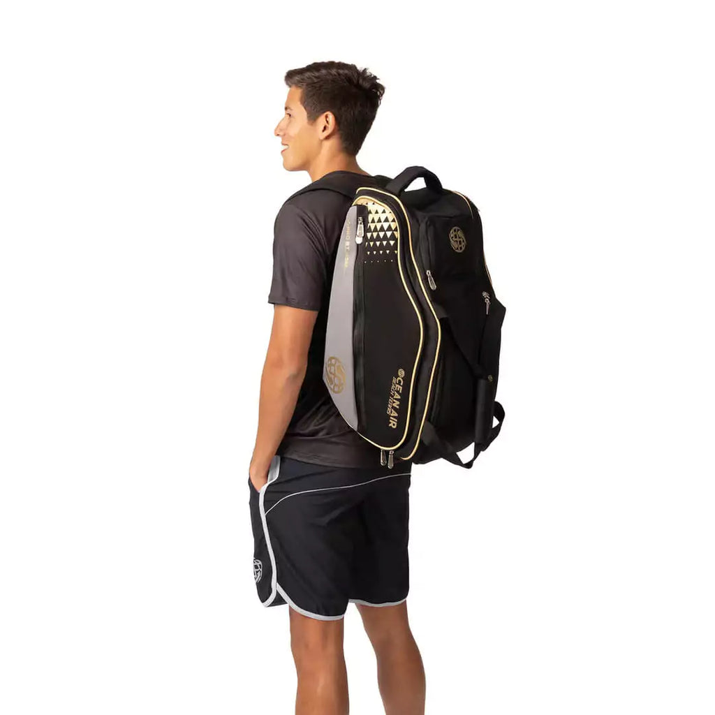 Shop BT Bags at iamRacketSports Colisium Store - Bag model is an Ocean Air Performanace PRO BT COMPACT bag in Black. Bag on the back of Diego Guzman a Beach Tennis Player.