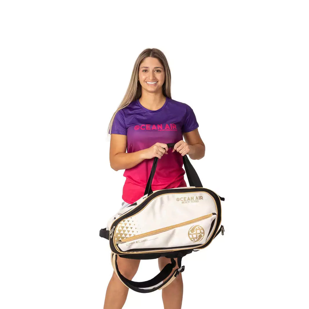 Shop BT Bags at iamBeachTennis, world wide shipping - Bag model is an Ocean Air Performanace PRO BT COMPACT bag in White. Bag carried by Marianne vargas a Beach Tennis Player.