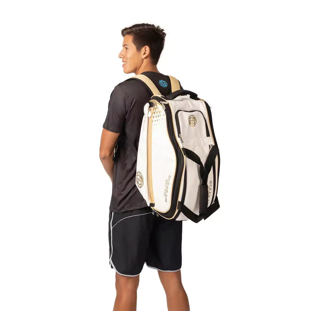 Shop BT Bags at iamRacketSports Colisium Store - Bag model is an Ocean Air Performanace PRO BT COMPACT bag in White. Bag on the back of Diego Guzman a Beach Tennis Player.