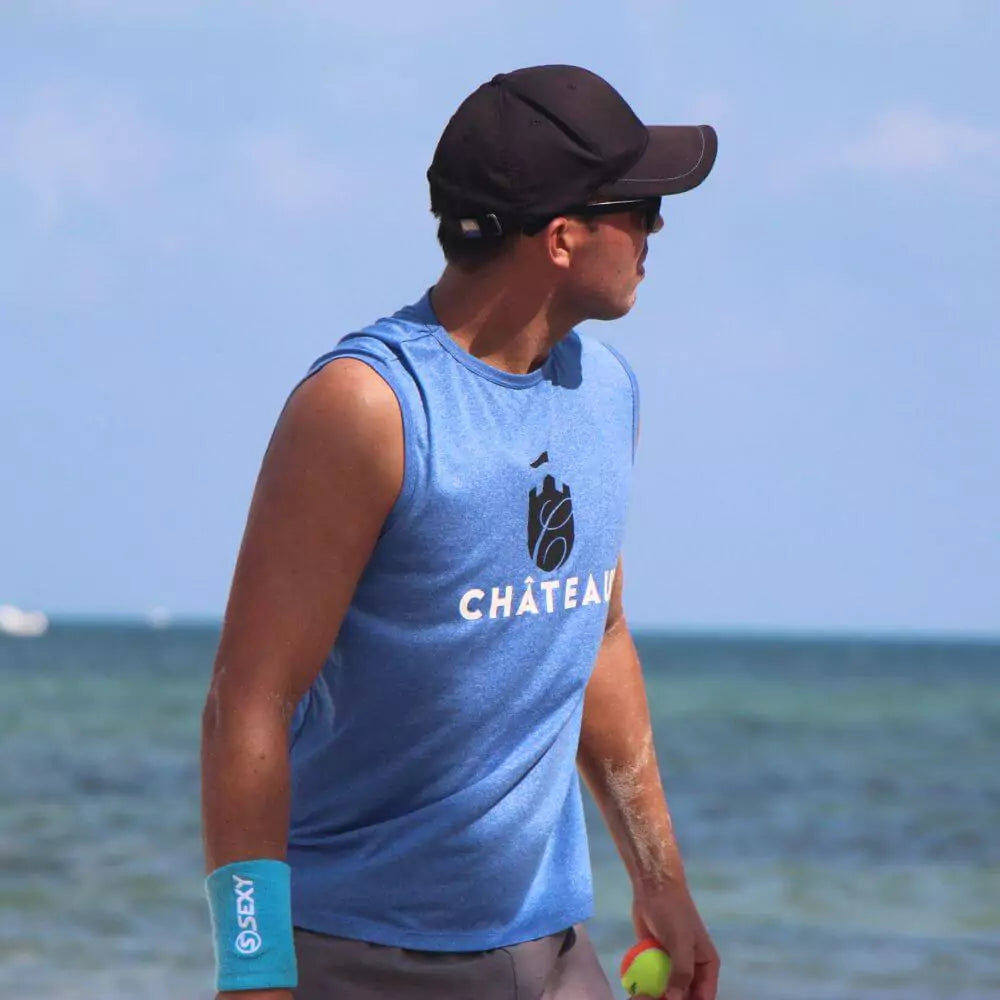 iamBeachTennis beach tennis boutique online store - Chateau Sportswear brand, a beach tennis player wearing a Chateau Classic Men's tank top in the color blue