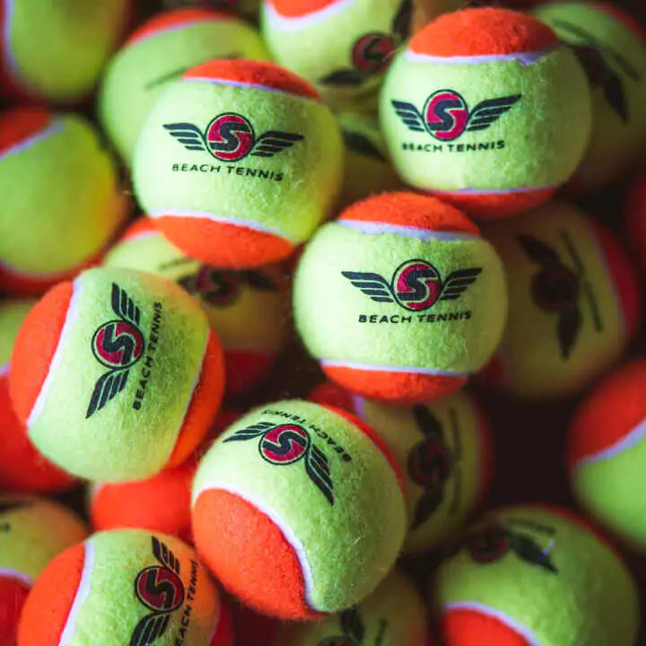 Shop Sexy Brand Beach Tennis at "iambeachtennis" an online store based out of Miami. Sexy Tropical S-Ball in Atomic Orange. Image shows close up of balls..