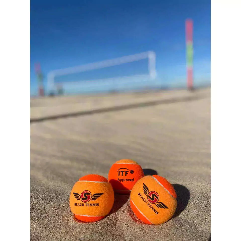 Shop Sexy Brand Beach Tennis at "iambeachtennis" an online store based out of Miami. Sexy Tropical S-Ball in Atomic Orange. Image shows 3 balls on the sand.