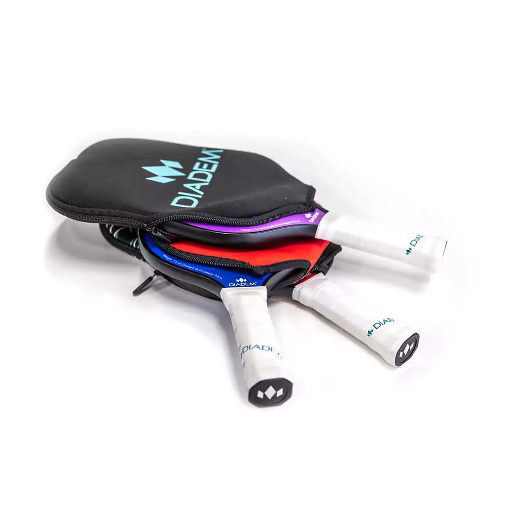 Shop iam-Pickleball a Miami Beach Boutique Store | iamRacketsports - Diadem Sports Pickleball Paddle Cover. Stack of rackets and covers.