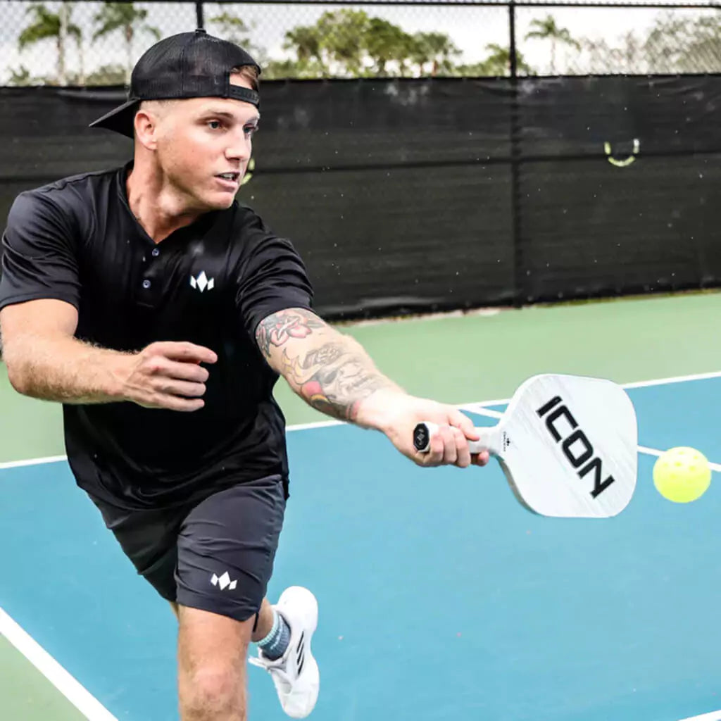 SPORT: PICKLEBALL. Shop Diadem at Pickleball at iamRacketSports/iam-pickleball, Miami, Florida, USA. Player volleying the ball with white Diadem Sports ICON V2 XL 2023 Professional Pickleball Paddle,  RP2 surface technology, Poly Honeycomb core weight 8.25oz.